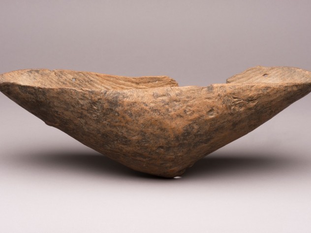 A wood coolamon by an unknown artist