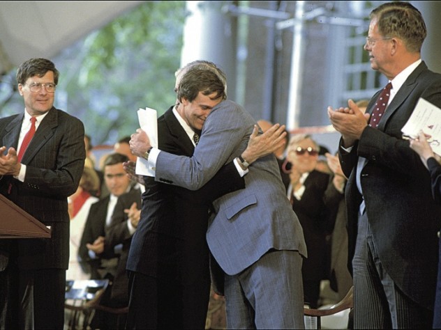 Photograph by Jim Harrison After delivering the Commencement afternoon address, retiring President Bok is hugged by president-elect Neil Rudenstine (1991).