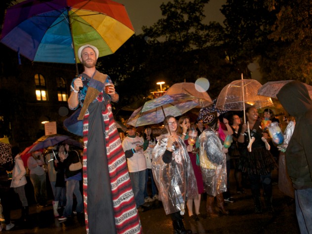 Photograph by Jim Harrison The Divinity School parade had a "pilgrimage" theme and was led by a colorful stilt walker.