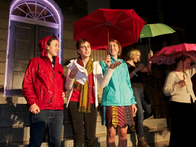 Photograph by Jim Harrison Student storytellers on the steps of University Hall had trouble making themselves heard over the rain.