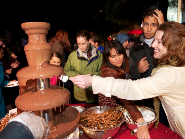 Photograph by Jim Harrison Party-goers enjoy one of two chocolate fountains. The food tents were popular as people crowded underneath to get out of the downpour.