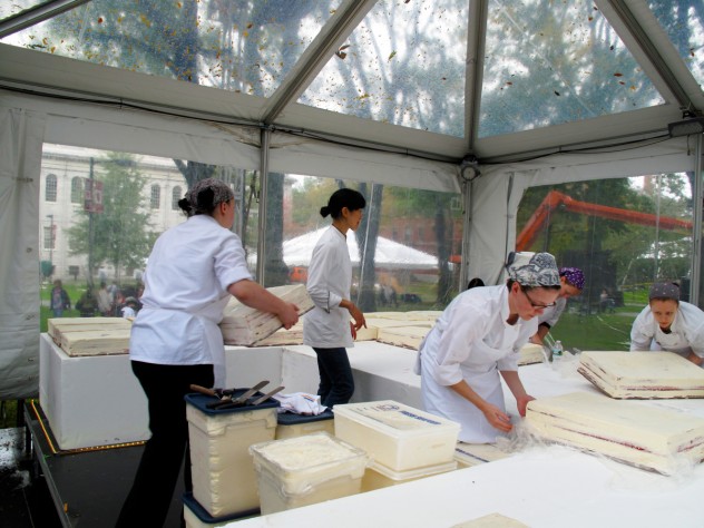 Photograph by Harvard Magazine/JC Employees unwrap and arrange the sheets as Flour owner Joanne Chang ’91 looks on.