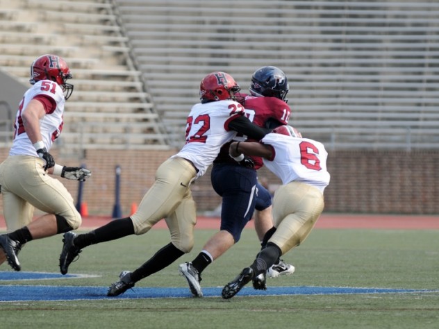 Mark Kelsey / Harvard Crimson Linebacker Jacob Lindsey (51) trails the play as safety Reynaldo Kirton (22) and cornerback Brian Owusu (6) bring down Penn quarterback Billy Ragone. Ragone rushed for 95 yards and a touchdown, passing for two more Quaker scores in a 30-21 upset.