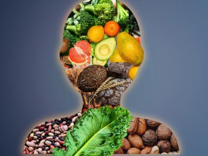 Silhouette of a human body comprised of food groups: fruit, nuts, legumes, vegetables, whole grains