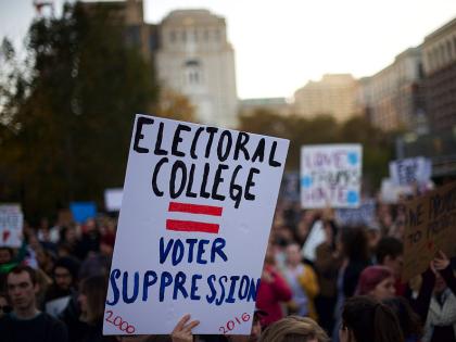 A protester holding a sign that reads "ELECTORAL COLLEGE = VOTER SUPPRESSION" on November 13, 2016.