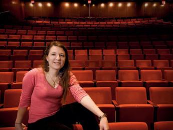 Mary Ellen Stebbins sits under the lights in the New College Theatre.