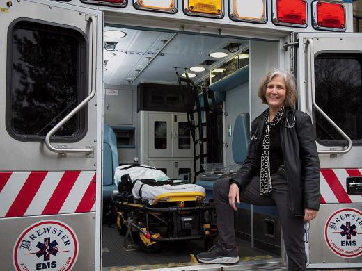 Pediatrician Eileen Costello stands next to the Boston Medical Center’s mobile pediatric clinic.