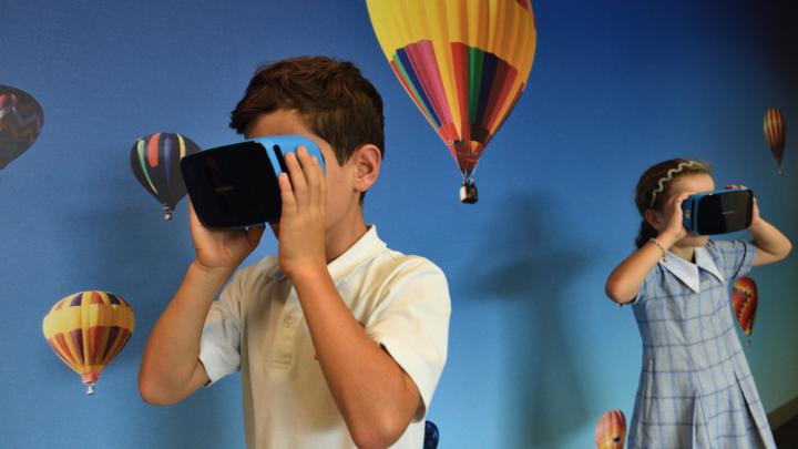 Boy and girl uses VR goggles