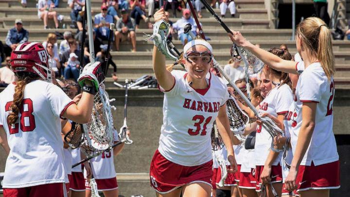 The Harvard women’s lacrosse team takes the field.