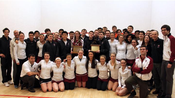 The men's and women's squash teams pose with their coaches—and their trophies.