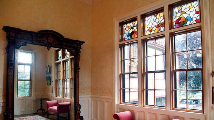 Highfield Hall’s large wall mirror, stained glass, and other architectural details