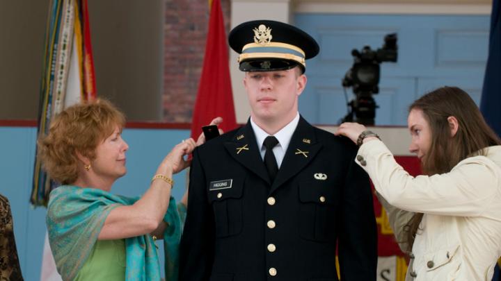 Second lieutenant Christopher Higgins has his bars pinned on by his mother and sister.