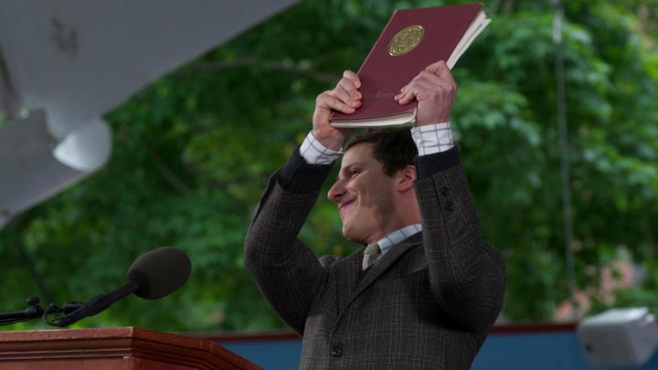 Andy Samberg holds up "the collected works of William Yates."