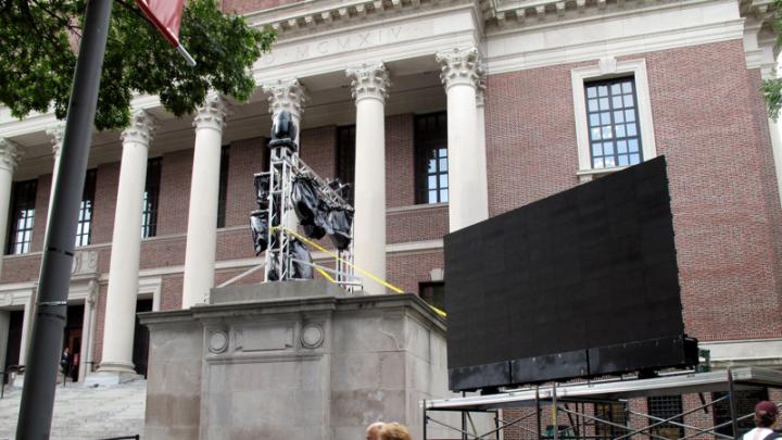 Tercentenary Theatre is being outfitted with four large LED projection screens, like this one flanking Widener Library, so guests can see the proceedings, a Harvard slide show, and—during the celebration—images of the 375th party and even, perhaps, themselves.