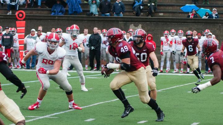 Linebacker Eric Medes ’16 (49), here picking off a second-quarter pass and returning it 12 yards, was a mainstay of a Crimson defense that held the Big Red at bay until the offense could get in gear.
