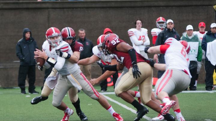 Under the watchful gaze of Langston Ward ’17 (number 92), defensive tackle Jameson McShea ’16 (number 89) swallowed up Big Red quarterback Jake Jatis for his first career sack—one of four the Crimson had on the day.