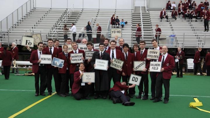 Band members display the signal cards for Harvard fight songs.