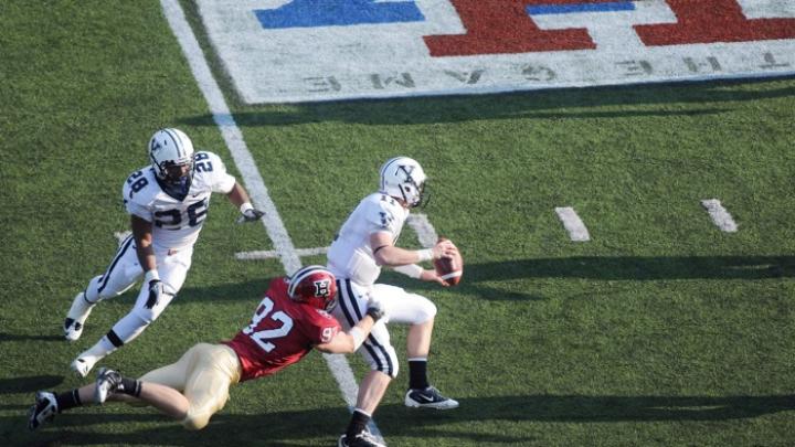 Yale quarterback Patrick Witt, the Ivy League’s top passer, was sacked six times by Harvard defenders. End Ryan Burkhead ’11 (92) had a career-high 2.5 sacks for a net loss of 20 yards. The Eli behind Burkhead is running back Mordecai Cargill.
