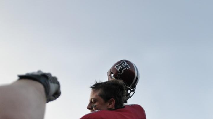 With Crimson in triumph flashing: Captain Collin Zych rode off on his teammates’ shoulders after the final whistle. The 28-21 victory was Harvard’s fourth straight over Yale, and its ninth in the last 10 Harvard-Yale games.
