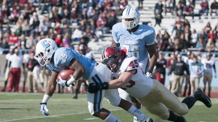 Strong defensive play held Columbia’s ground game to a net 49 yards rushing. Above, senior linebacker Matt Martindale (45) hauls down tailback Alan Watson. Martindale finished the game with five tackles and a quarterback sack.