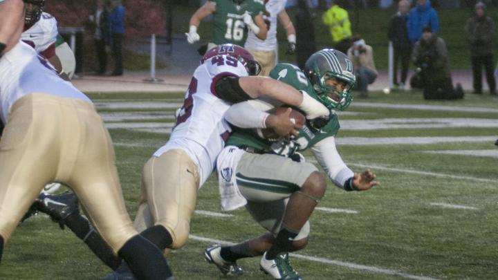 Junior linebacker Eric Medes (number 49), who had seven tackles, bottled up Dartmouth quarterback Dalyn Williams. The Harvard defense forced five fumbles, two of which the Crimson recovered. 