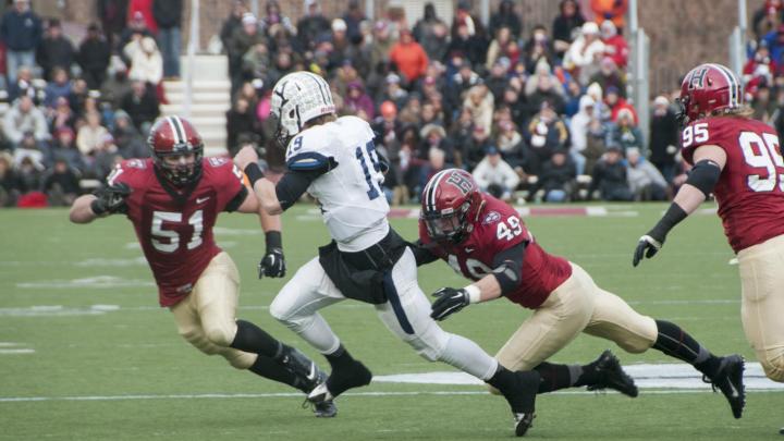As so often happened this season, an opposing quarterback—in this case, Yale’s Morgan Roberts—had nowhere to run against marauding Crimson defenders such as linebackers Jake Lindsey ’16 (number 51) and Eric Medes ’16 (number 49), who were helped by defensive tackle Miles McCollum ’17.