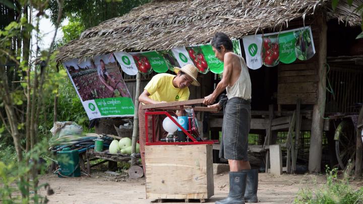 A rural agency distributes Proximity Designs' equipment, such as the pump being demonstrated here.