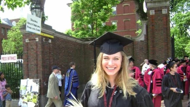 Unidentified 2010 graduate holds a symbolic sheaf of wheat. 