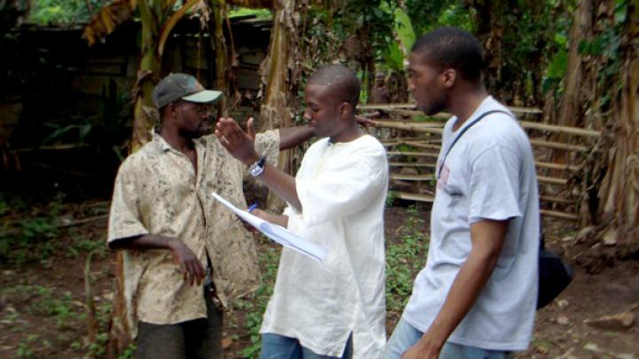 Delle, who grew up in Accra (24 kilometers south of Agyementi), discusses a latrine site with Okereke (right) and the youth representative from the village.