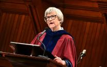 Drew Gilpin Faust in robes at the podium in Sanders Theater