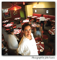 Chef de cuisine Corrina Mozo in the dining room at Chez Henri. In college she would go back to her room and read cookbooks. Photograph by John Soares.