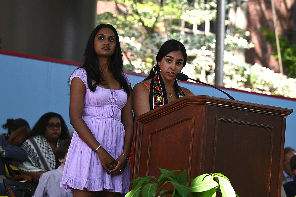 two women speak at podium