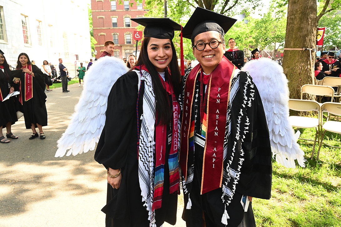 Two students with white wings on their backs 