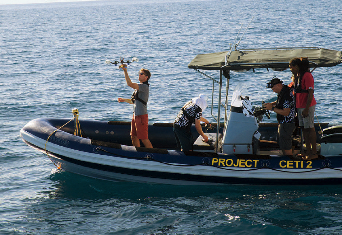 Rob Wood holding up a drone aboard one of Project CETI's skiffs