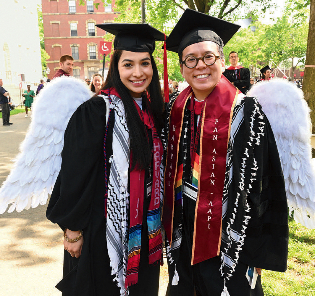 Divinity students Maria Dueñas Lopez, M.T.S. ’24, and Frances S. Lee, M.Div.’ 24 wearing wings