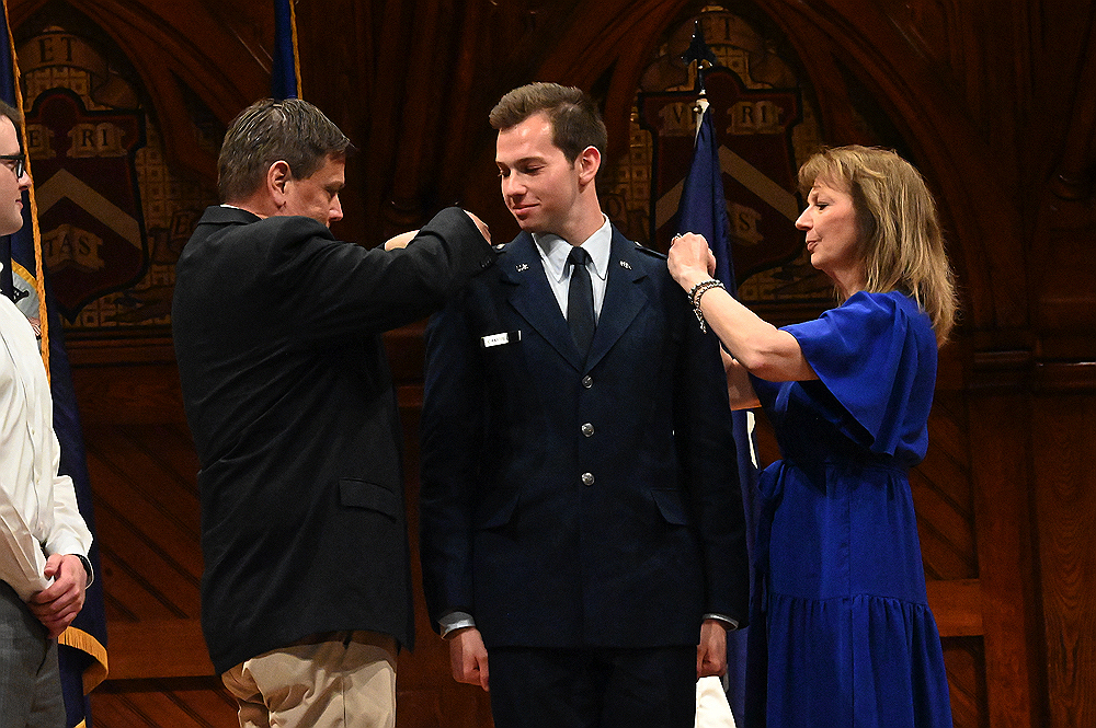 Cadet being pinned by family memebers