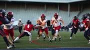 Harvard player #16 runs with the ball with Penn players in pursuit