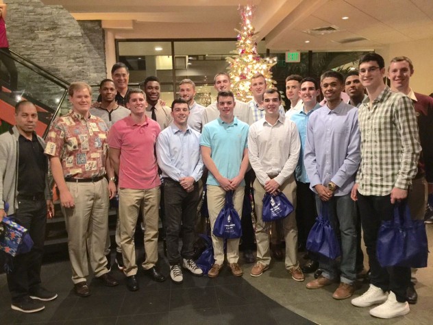 Former Honolulu mayor and Harvard basketball alumnus Mufi Hannemann '76 (first from left in the back row) hosted the team and a group of fellow alumni at a Christmas Eve dinner at a Waikiki restaurant. Following the tournament, Hannemann said he had "never been prouder" of the Harvard team.