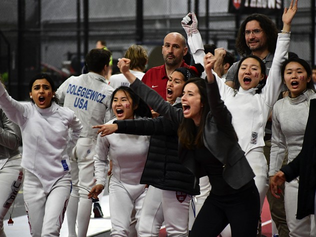 Coaches and members of Harvard's women's fencing team celebrate