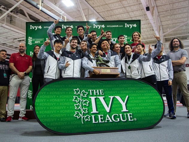 The Ivy champion men pose with their first-place trophy.