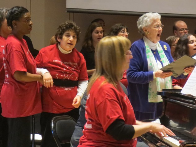 Courtesy of Gary Herman Composer, conductor, and arranger Alice Parker joins Joyful Noise and Collegium members in song. At the piano is the associate director of Joyful Noise, Cathy Sonnenberg; the group’s co-founder, Beth Fromm, stands second from left.