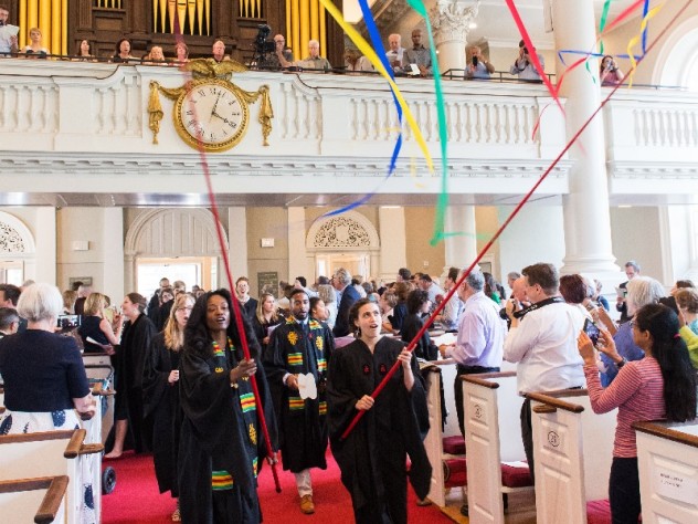 Graduating students carry streamers into Memorial Church.
