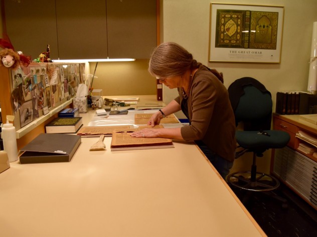 Photograph by Zara Zhang/Harvard Magazine A book conservation specialist works on the preservation of rare books in Widener’s Conservation Lab, located in its basement.
