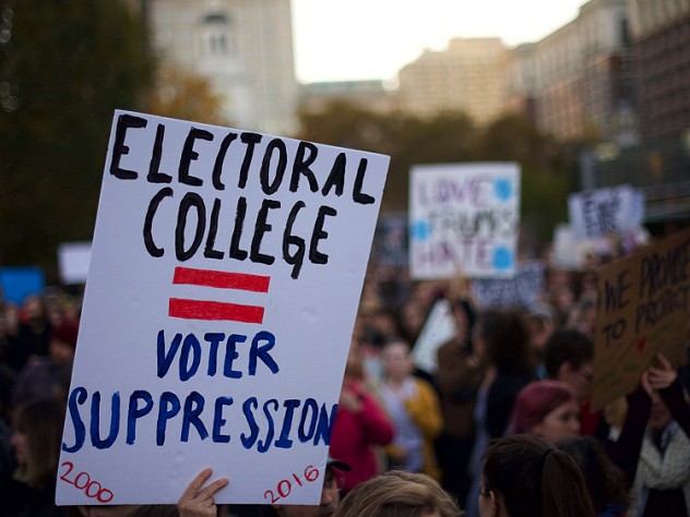 A protester holding a sign that reads "ELECTORAL COLLEGE = VOTER SUPPRESSION" on November 13, 2016.