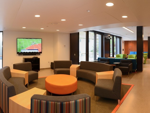 Jim Harrison Couches, a flat-screen TV, multicolored chairs, and a brand-new kitchen have transformed the basement of the newly renovated Old Quincy into an appealing community room.