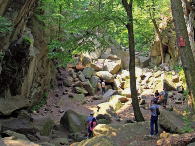 Hikers stand in Purgatory Chasm, near Worcester, Massachusetts