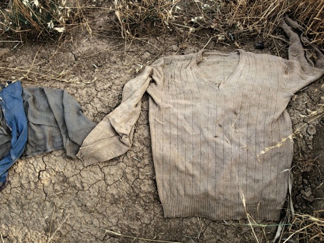 Photograph by Susan Meiselas/Magnum Photos Arbil cemetery, Northern Iraq. 1991. “People had already dug up the bones to try to find their loved ones as soon as the uprising against Saddam’s forces was over. They dug up the graves, found the clothing around the bones, and, if it wasn’t their kin that they found, they put the clothing on the graves so the next person didn’t have to dig it up.” —Interview with Susan Meiselas by Kristen Lubben, from <em>Susan Meiselas: In History.</em> From the series <em>Kurdistan</em>