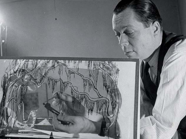 Award-winning set designer Jo Mielziner touches up a figurine for a set design executed on a glass pane in this January 1945 photograph.