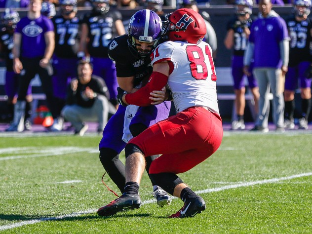 Brogan McPartland tackles Holy Cross quarterback Connor Degenhardt for a loss.
