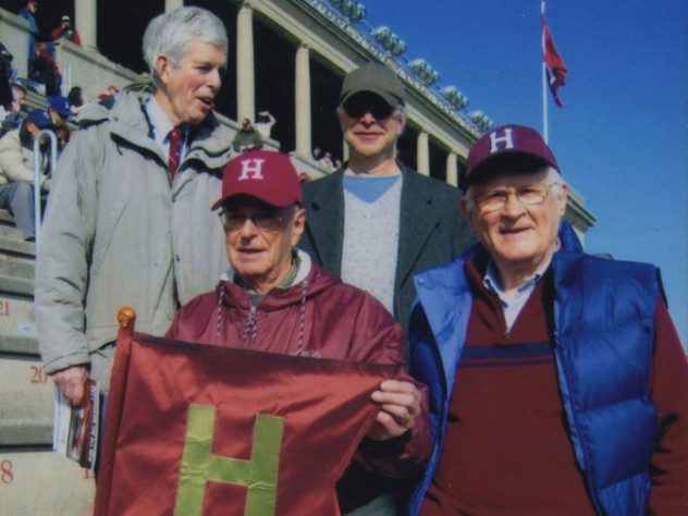 Paul Lee (left) holds the Little Red Flag replica in 2012. Also shown (clockwise from top left) are Spencer Ervin, Jeffrey Lee, and Stephen Goodhue.